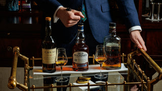 A brass drinks trolley with three whiskies, two nosing glasses and two tins of Attilus caviar at The Delany Drawing Room.